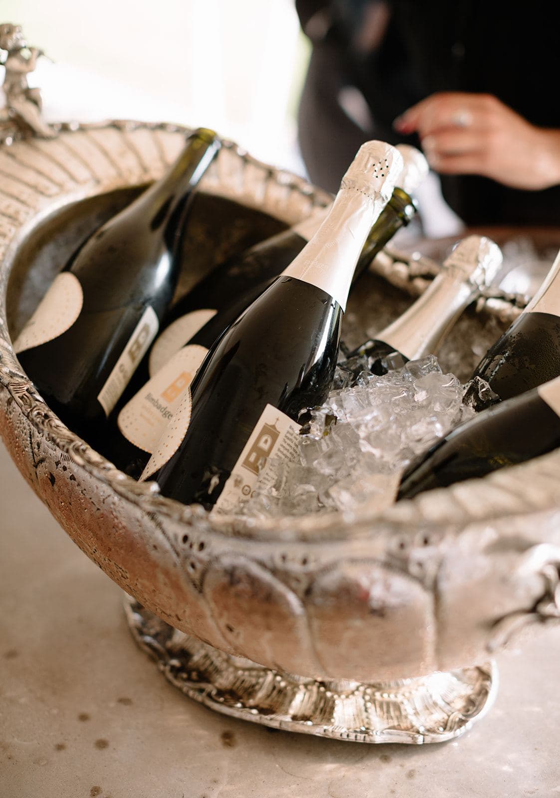 Champagne bottles on ice in a silver urn