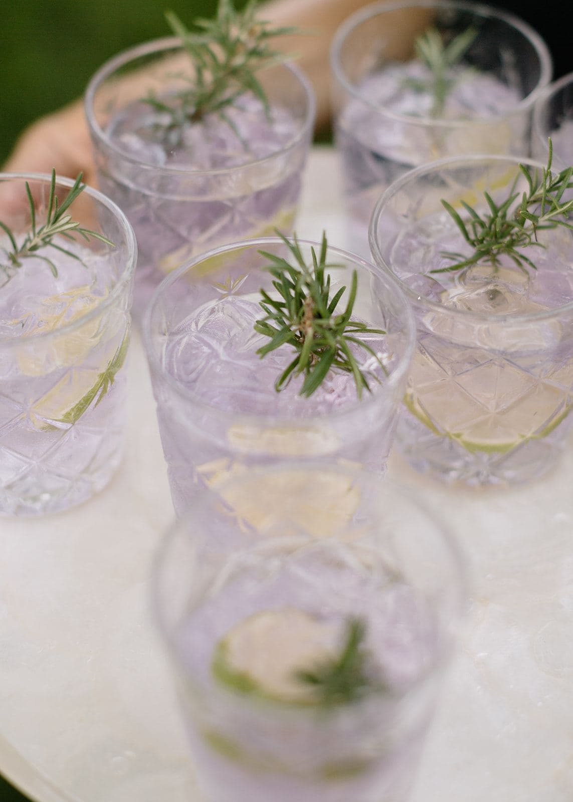 Rosemary garnished cocktails on a tray