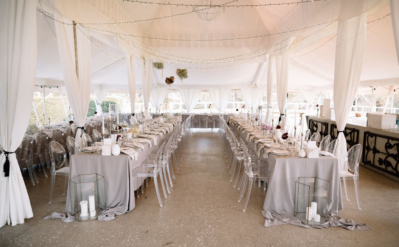 Marquee wedding reception with long tables and ghost chairs